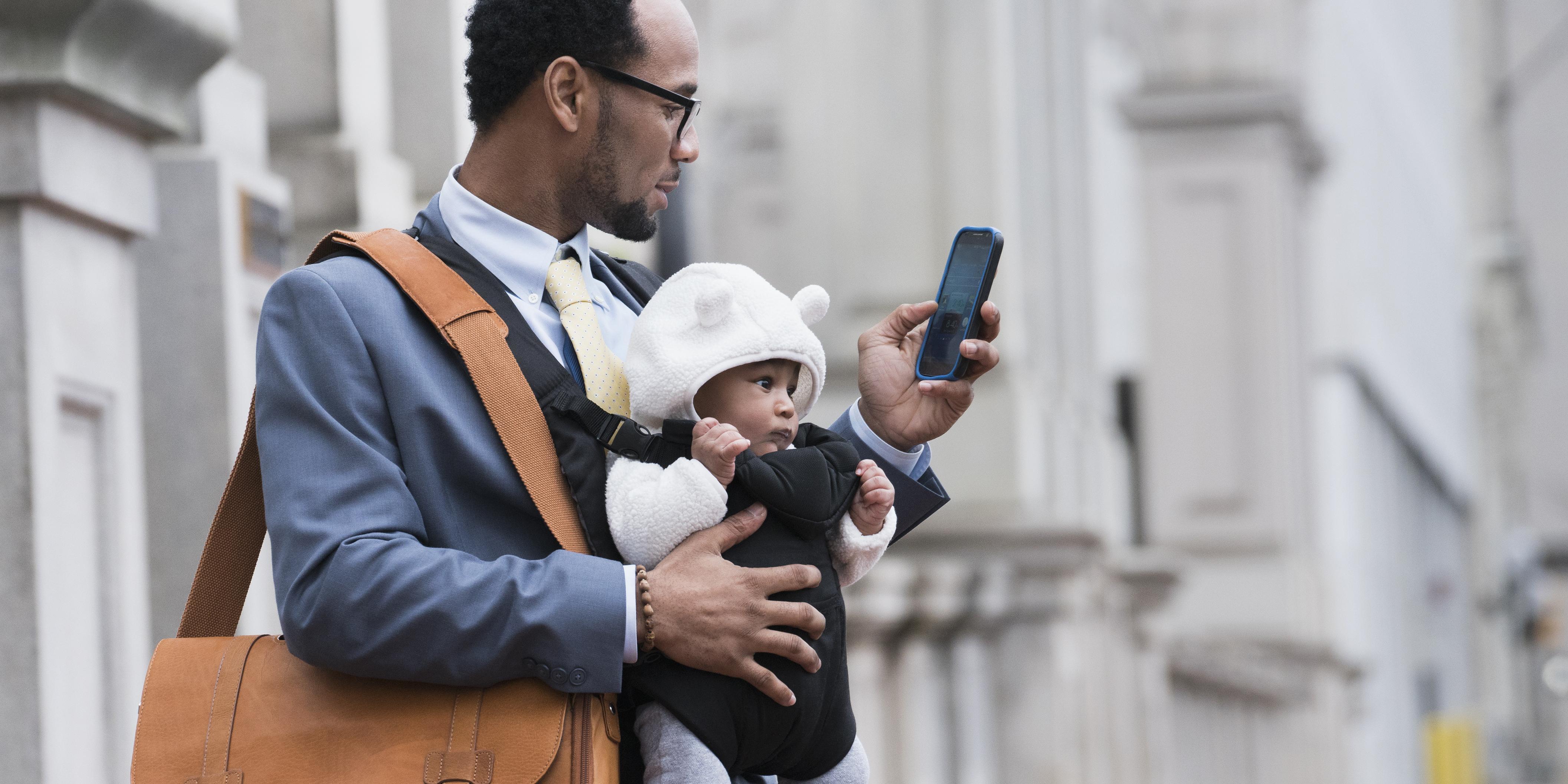 Person with baby looking at phone